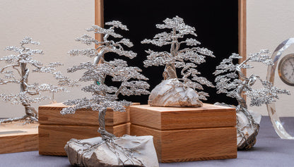 Stainless steel maple trees on rock and on solid oak boxes, memory boxes and memorial trees