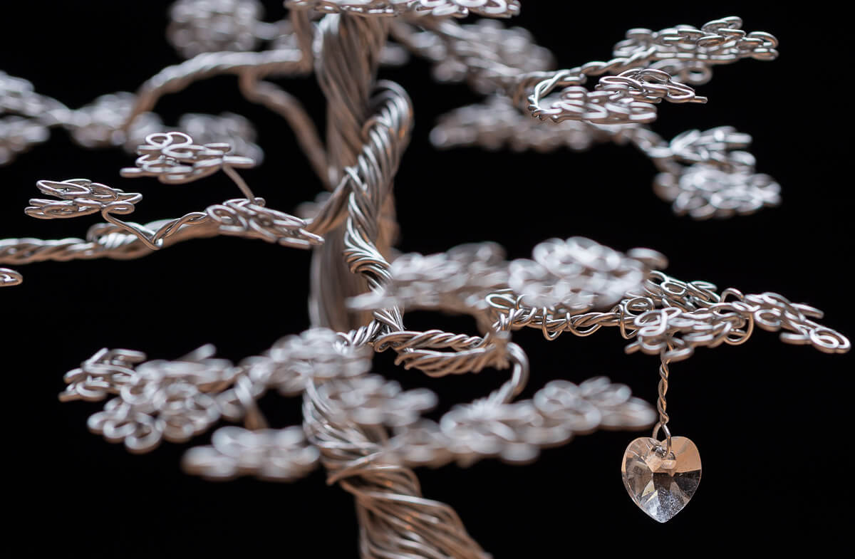 Stainless Steel Tree against black background with crystal heart