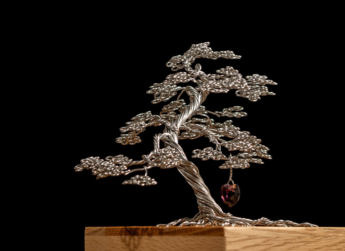 Memory box, memorial tree in stainless steel mounted on a solid oak box, lined with black velour. Shown with amethyst green crystal heart.