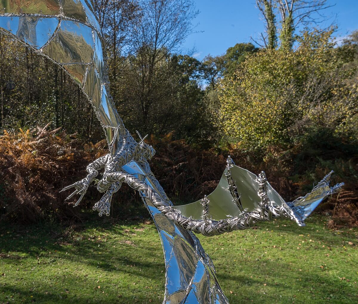 Stainless steel dragon sculpture close up from behind